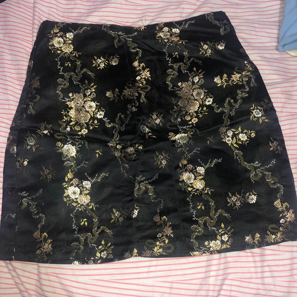 A black skirt with gold detailing